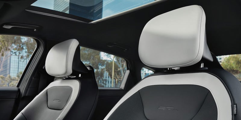 Interior view of car seats and panoramic roof.
