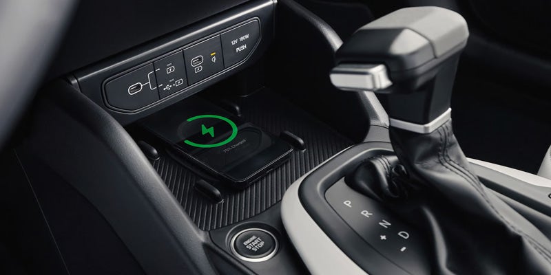 Car center console with gear selector and drive mode controls.