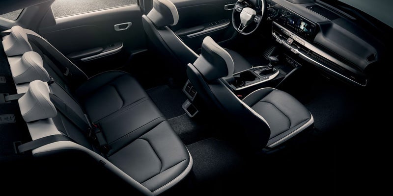 Interior view of a Kia K4 showing front and rear seats and cockpit.