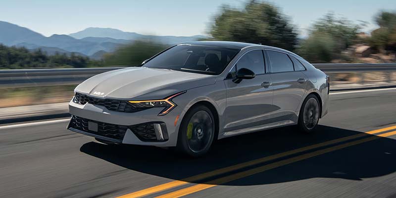 2026 Kia K5 sedan driving on highway