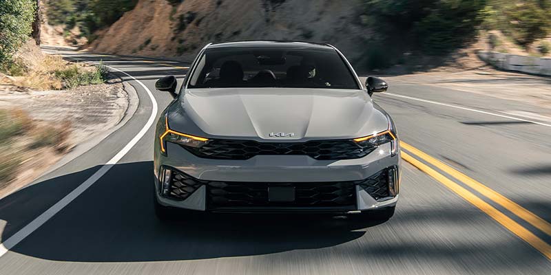 2026 Kia K5 sedan front view driving on road
